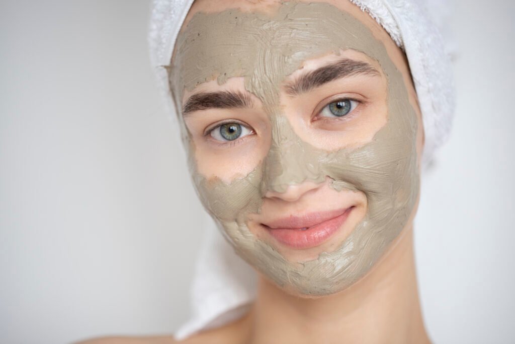 portrait beautiful woman with beauty clay mask her face